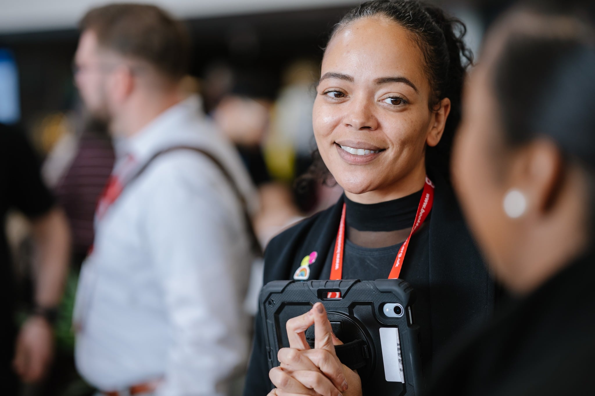 An ICB member bookkeeper smiling in conversation at a professional event.